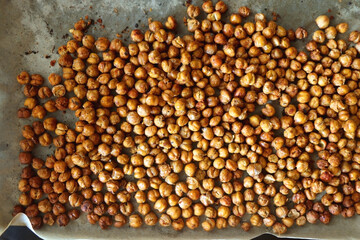 Sheet pan with homemade roasted chickpeas. Top view.