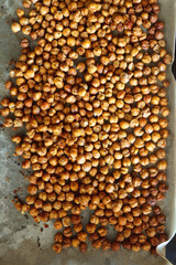 Sheet pan with homemade roasted chickpeas. Top view.