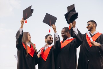 Joyful Graduates Celebrating Their Academic Achievement With Caps in the Air