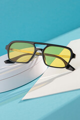 Artistic display of colorful sunglasses on white background.