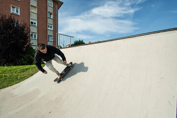 Fish-eye view of a skater launching off the half pipe