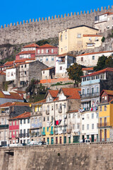 A rough and raw view of the city Porto with old ancient rusty buildings, castle wall protrudes...