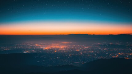 Obraz premium A serene twilight view over a cityscape with distant mountains and starry sky.