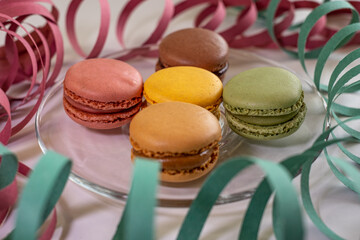 Close up of different pastel colored macaron cakes filled with cream. Culinary and cooking concept. Tasty colorful macarons
