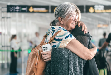Couple of women hugging and goodbye in airport area for arriving or departing trip, feeling for...
