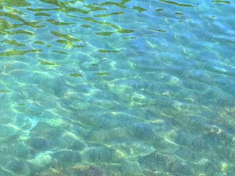 Sea clear green blue water surface.
