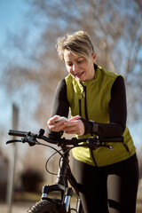 Woman Standing Next to Bike Using Cell Phone