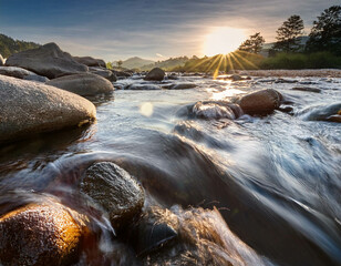 Obraz premium A macro shot of rippling water over smooth river stones, capturing the intricate textures