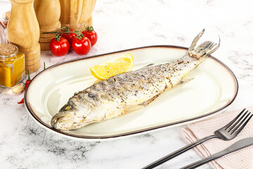 Grilled sea bass fish served lemon