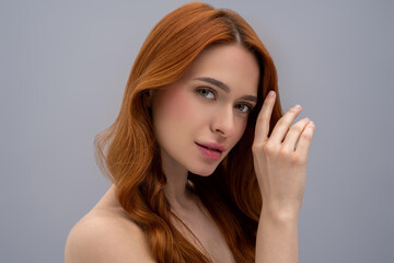 Pretty ginger long-haired young woman looking relaxed