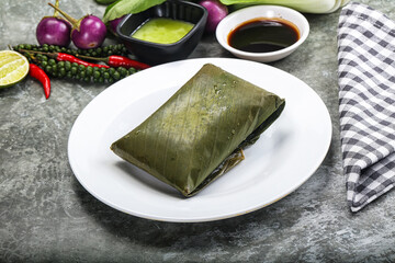 Asian cuisine - rice with filling in banana leaf