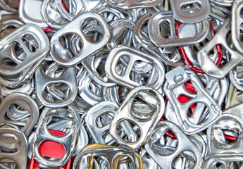 Close up of metal ring pulls from aluminum can caps. Aluminum pull ring