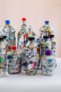 Group of ten bottles of PET filled with plastic waste for upcycling and ecobricking
