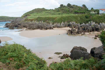 Aerial view of a rocky sandy beach in Llanes, Asturias. Barro beach.