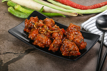 Manchurian chicken with sauce and spices