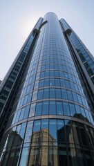 Obraz premium Low-angle shot of sleek curved skyscraper showcasing future architecture with glass windows