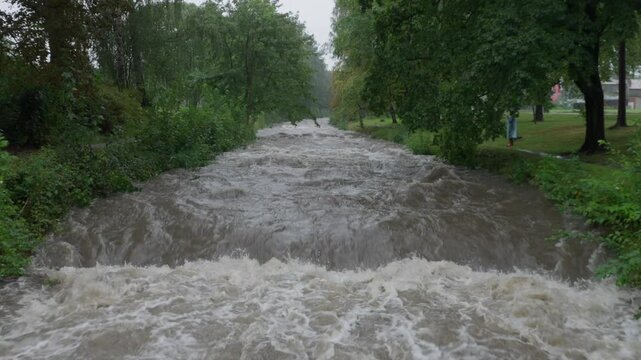 Stranger walking by the strong current of river