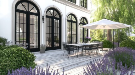 This exquisite white shipping container house features black windows and is surrounded by vibrant lavender bushes, offering a serene outdoor dining area under bright sunlight