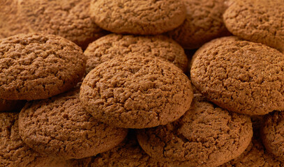 Oatmeal cookies placed throughout the screen selective focus. Food background.