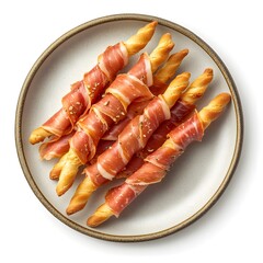 Delicious breadsticks wrapped in prosciutto served on a ceramic plate