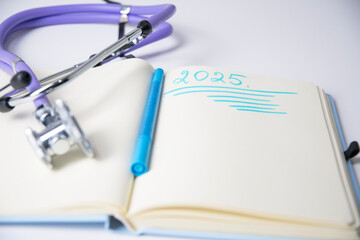 Stethoscope notepad with the word 2025 written in blue on paper symbolizing the future of healthcare in the new year,