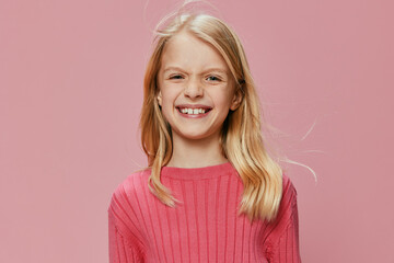 Happy Schoolgirl with a Stylish Pink Backpack and a Joyful Smile A beautiful young girl, radiating joy and excitement, stands confidently in a pink studio As she holds her stylish backpack, her cute