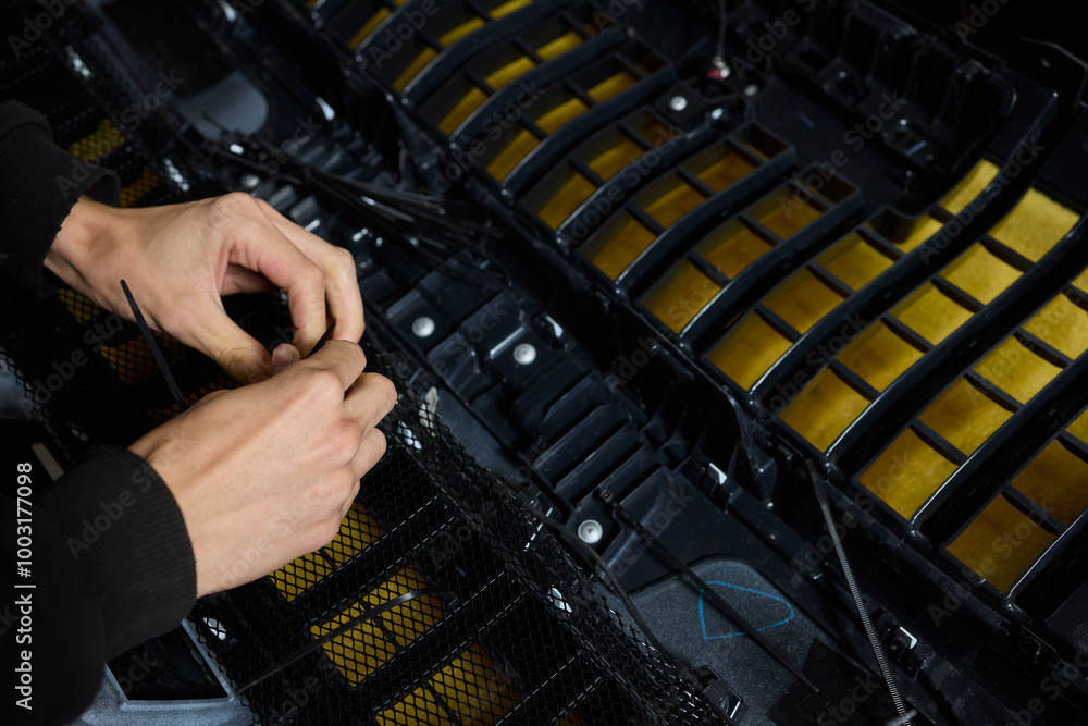 Poster hands skillfully engaged in the complex and detailed process of mechanical assembly work