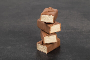 Milk souffle. In chocolate. Dark gray background