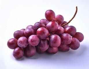 Fototapeta premium A bunch of purple grapes with one separate grain, focus on the skin texture isolated on white background