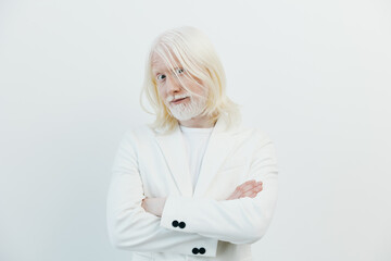 Portrait of a confident elderly man with long white hair and beard, wearing a stylish white suit,...