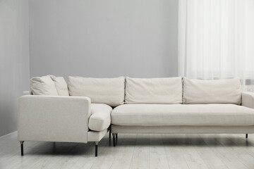 Stylish room interior with comfortable sofa and window