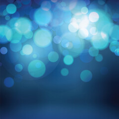 Blue bokeh. Blurred dark background with glowing light circles. Bright festive backdrop.