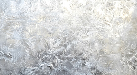 Texture of ice patterns on glass in winter frost. Christmas background with frosty pattern. Winter background concept.