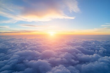 During sunrise or sunset, the yellow light of the sun is accompanied by soft blue clouds above peak mountains