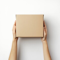 Fototapeta premium Hands holding a plain brown cardboard box on a white background. Package delivery concept.
