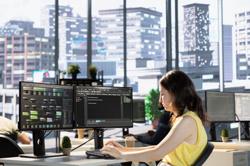 Employee conducting code review to fix bugs, identifying performance and technical issues with...