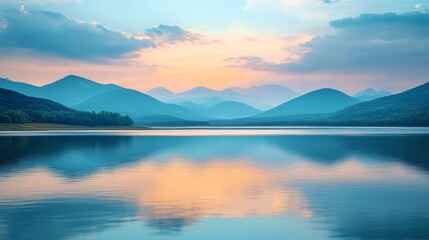 Fototapeta premium A beautiful lake with mountains in the background. The sky is a mix of blue and orange, creating a serene and peaceful atmosphere