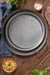 Empty metal plate on a brown rustic background. Top view.