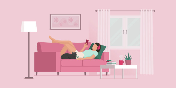 Girl relaxing on the couch and social networking on her smartphone