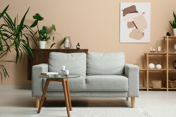 Interior of modern living room with sofa, coffee table and burning candles
