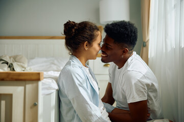 Obraz premium Young affectionate couple in their bedroom.