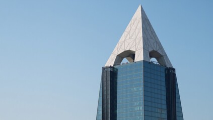 A neo-futurist glass  steel tower showcases a creative white triangular geometric dome in a striking futuristic architectural design Photo