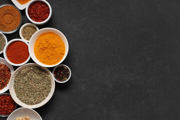 Composition with bowls of different aromatic spices on dark background