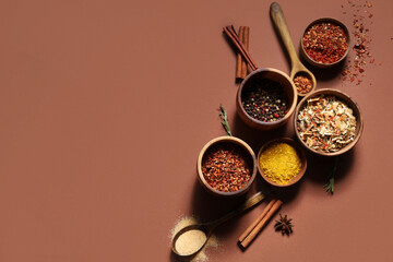 Composition with fresh aromatic spices on brown background