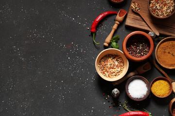 Composition with various fresh spices on dark background
