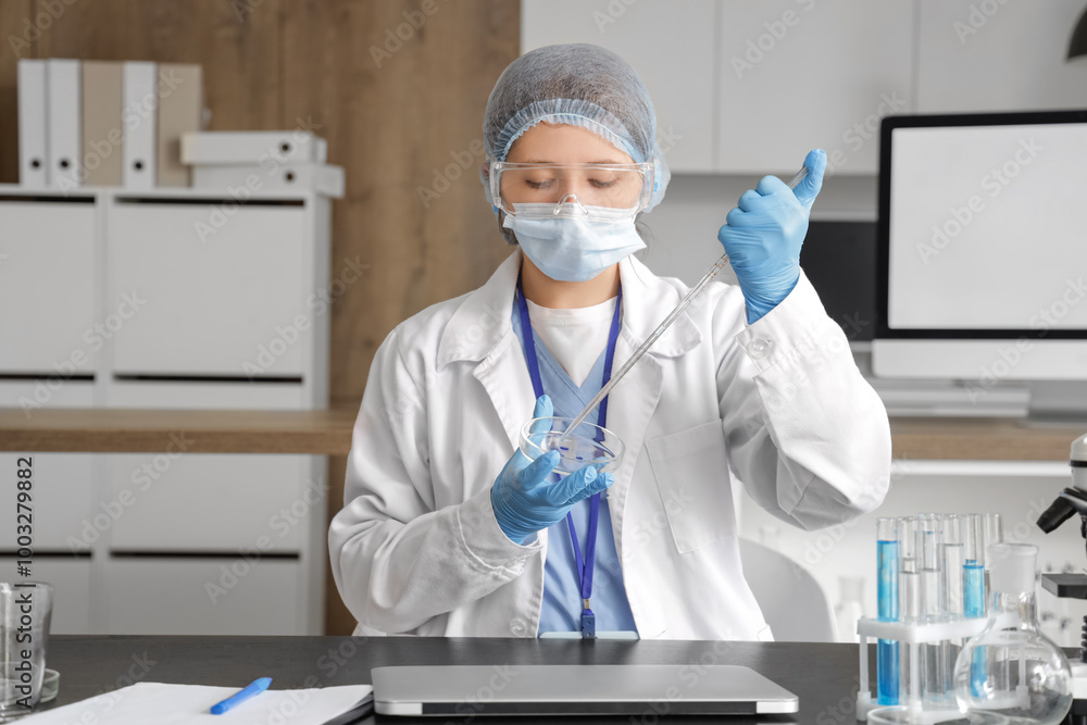 Canvas Prints Female scientist working with Petri dish at table in laboratory