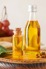 Bottles of cosmetic grape seed oil on white background