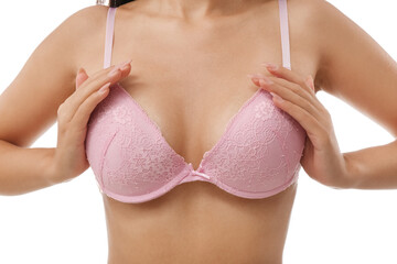 Young woman in pink bra on white background, closeup