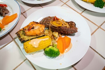 delicious plate of beef steak shrimp and veggies at latin american restaurant