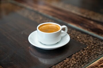 Obraz premium double espresso shot in short coffee mug at rustic cafe